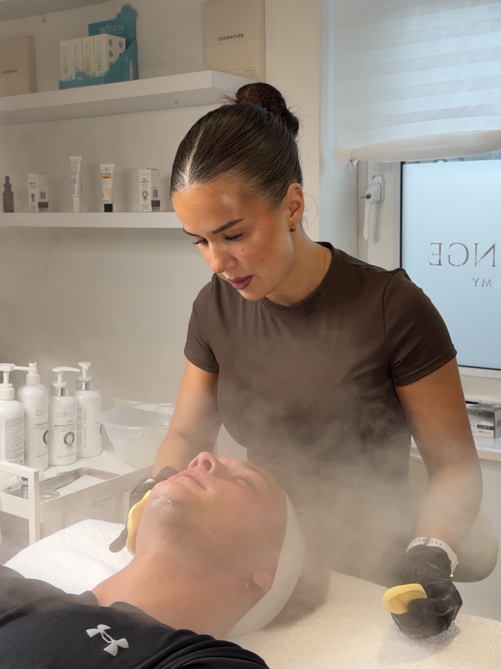 Natasha performing a facial treatment at The Faced Studio